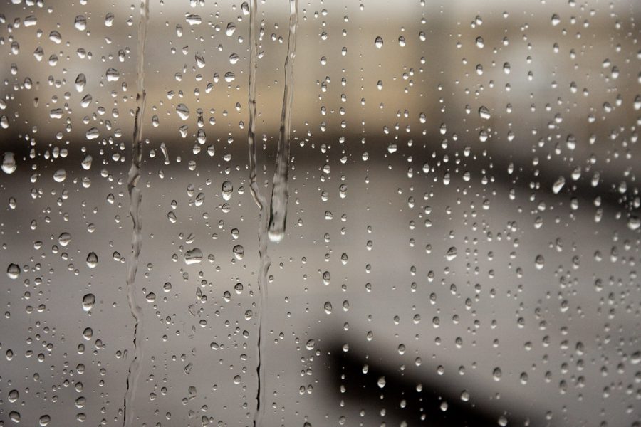 The view of rain from inside a window.