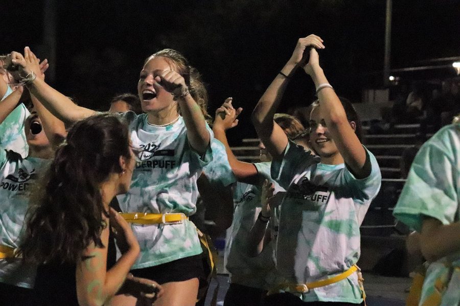 Members of the junior Powderpuff team cheer after their team scores a touchdown.