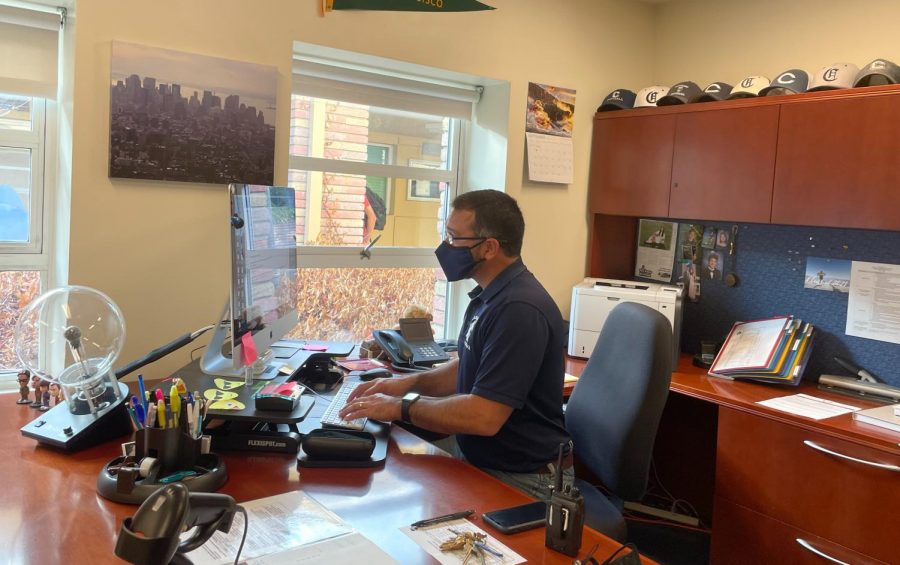 Ralph Crame, the principal at Carlmont High School, prepares for his busy day at work by first looking at his abundance of emails.