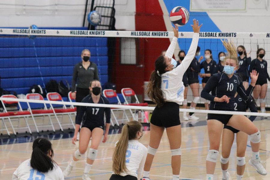 During a block, Christina Campie, a middle blocker for the Knights, touches Carlmont sophomore Lillian Fox’s spike. I definitely could have played better, but I think we played and lost as a team and thats the most important part, Campie said.