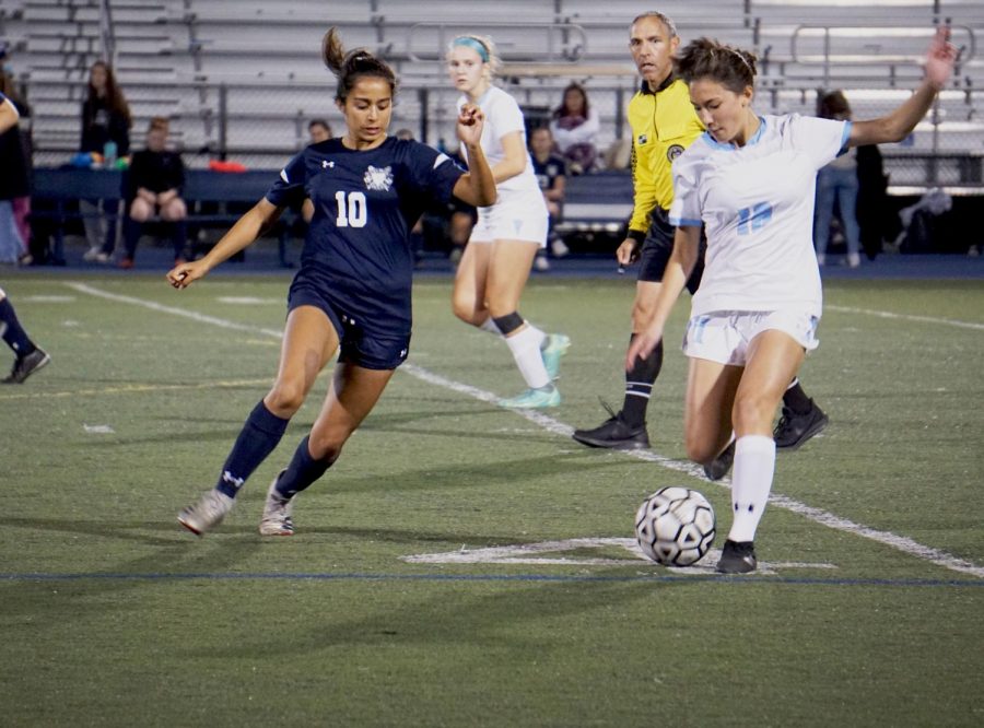 Sophomore midfielder Sanjana Hazari moves in to block a pass from a Hillsdale opponent.
