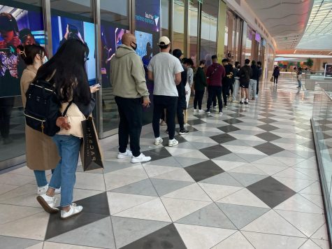Black Friday shoppers stand in a line outside of a store at Valley Fair Mall in Santa Clara.