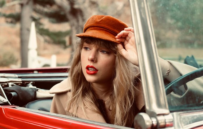 Taylor+Swift+sits+in+a+red+car+to+fit+the+thematic+photo+shoot+for+Red+%28Taylors+Version%29.