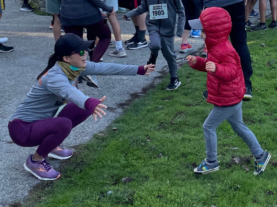 Karen Miaos son rushes into his moms welcoming arms before the start of the race. I hope turkey trot will be a tradition [because] this is my son’s first time, Miao said.