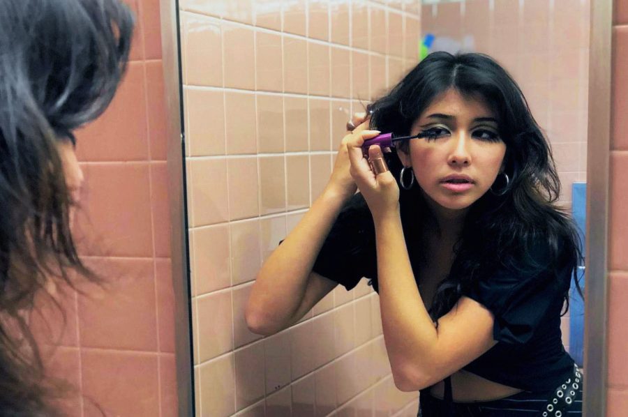 Carlmont sophomore Lilli Haggard applies makeup in the school bathroom. My makeup today is 60s inspired, Haggard said.