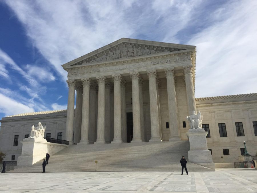 Security+guards+stand+outside+of+the+U.S.+Supreme+Court+building.