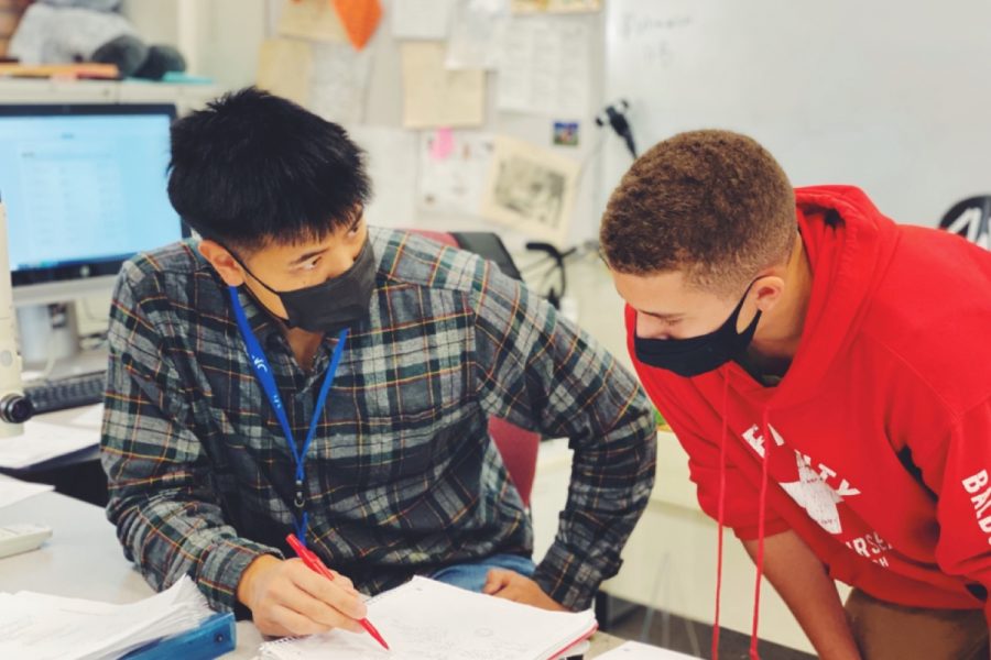Ryan Chun helps one of his students with a math problem during student flex time. 