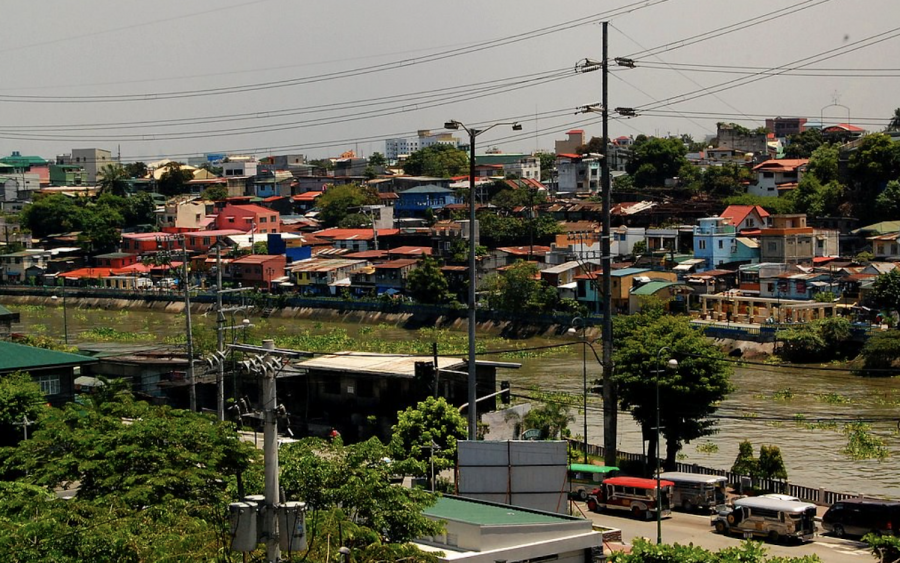 Densely populated houses sit at the edge of the Pasig River, which flows through the Philippines.