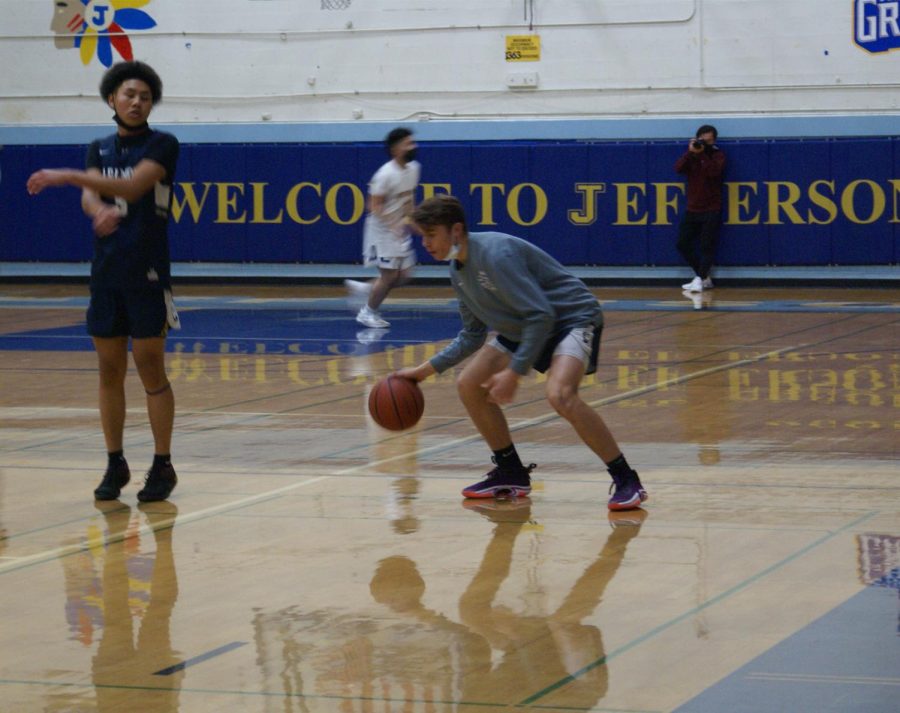 Carlmont warms up in preparation to start the game, taking turns dribbling and shooting the ball.