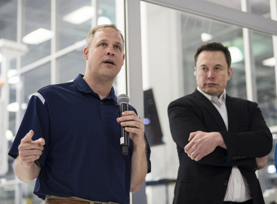 NASA Administrator Jim Bridenstine and Space X creator, Elon Musk stand together at the Space X headquarters. 

