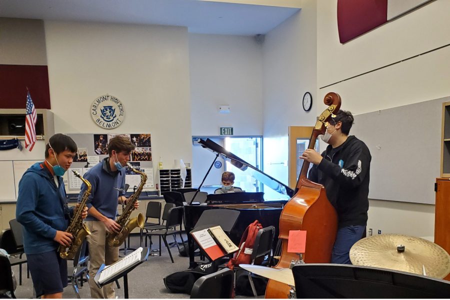 Members of jazz ensemble, Jack Peacock and Ethan Htun on saxophone, Lorenzo Wolczko on bass, Maya Campbell on drums, and Andrew Boldi on piano jam together during FLEX in the band room.