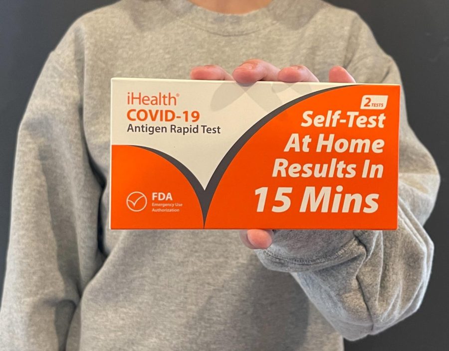 Maya Brazil holds up the iHealth COVID-19 Antigen Rapid Test that was distributed to Carlmont students on Jan. 4, I havent used any of the tests yet but its really nice knowing that I have some,  said Brazil.