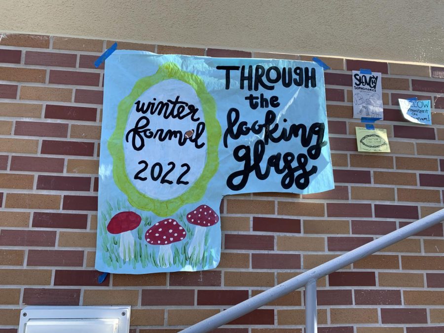The poster for the Winter Formal hangs in the quad, but the date has been cut out because of the dance being postponed.