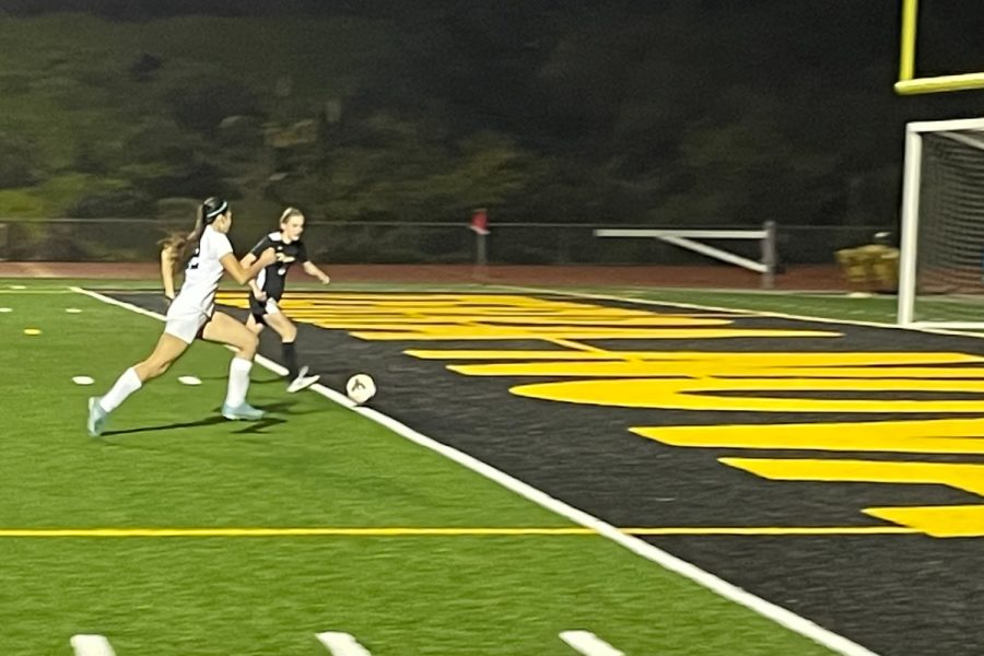 Isabella Rice dribbles the ball before it is taken by a defender.