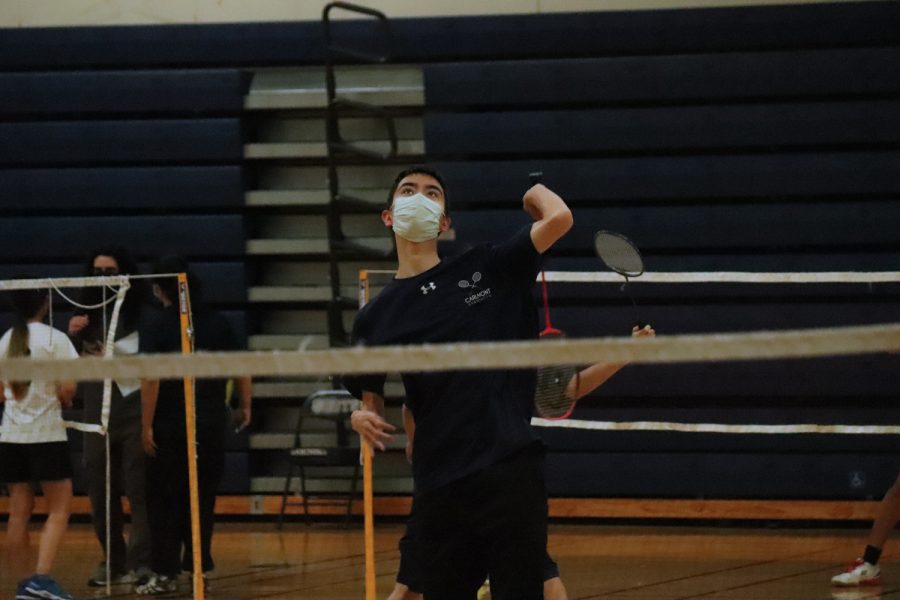 Senior Ethan Hsu smashes the birdie over the net.