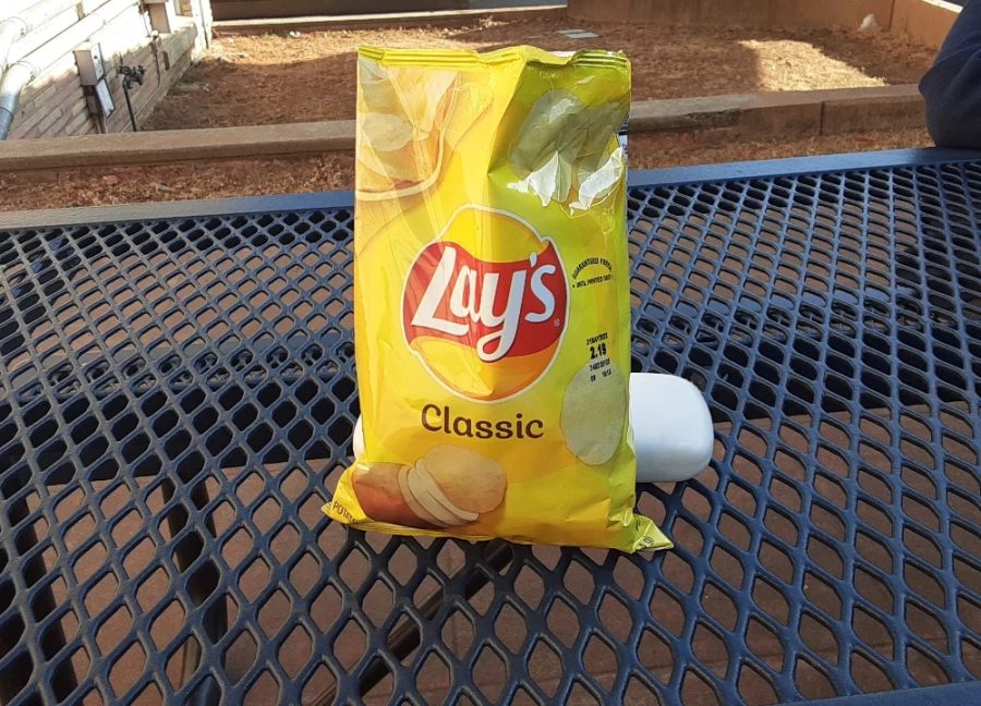 A yellow bag holds the Lays classic chip variety.