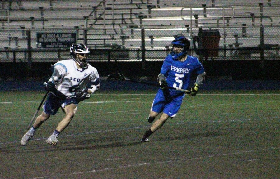Senior midfielder Ethan Matsuda attempts to get past Panthers with ball in possession.