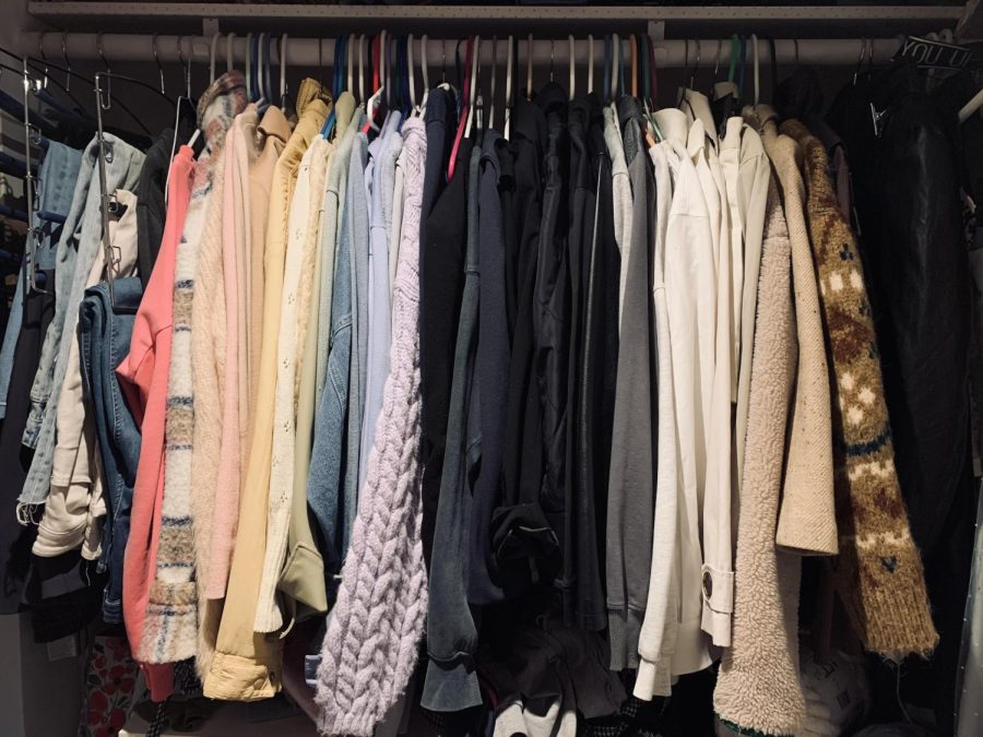 A closet full of various clothes, waiting to be worn by its owner. 
