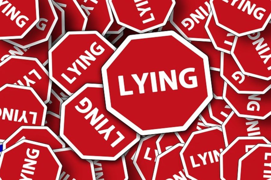 Red+lying+signs+cover+up+the+background%2C+showing+how+many+lies+we+tell+every+day.