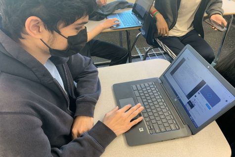 A sophomore studies for his math test by rewatching his teachers lectures on his chromebook.