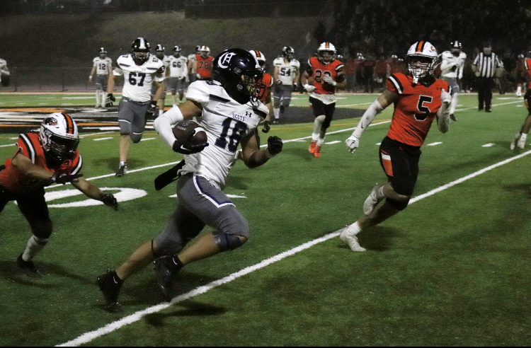 John Hanna, a senior running back, races the ball down the sideline as he tries to lead a comeback in the fourth quarter. Hes done an excellent job, said Head Coach Eric Rado. He is very durable and a great athlete.