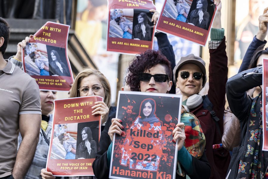 Protesters hold pictures of 22-year-old Mahsa Amini and other victims of the Islamic Republic.