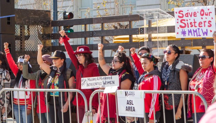 Protestors in a 2018 march through San Francisco raise their fists in solidarity with missing and murdered indigenous women.