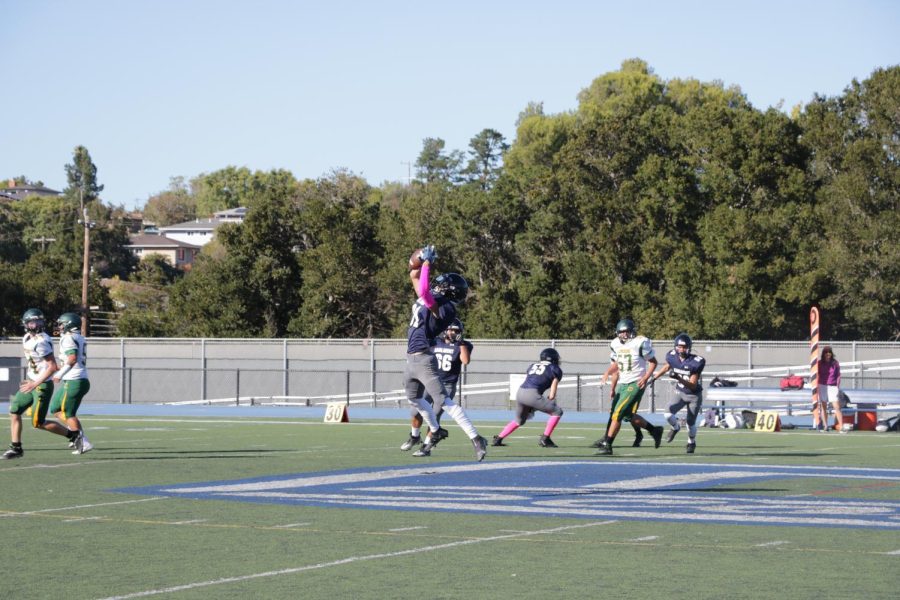 Daniel Mattioli, sophomore wide receiver, catches the ball before scoring a touchdown. 