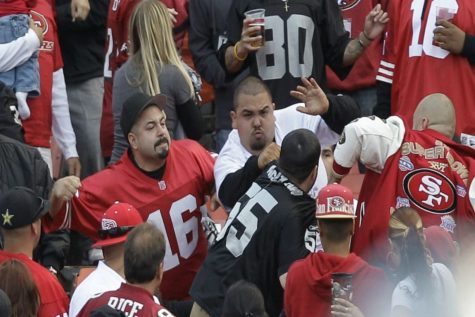 Football fans fight in the stands during a preseason NFL football game between the San Francisco 49ers and the Oakland Raiders in San Francisco. 