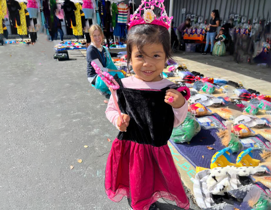 A little girl tries on a princess costume at the Una Vida costume drive. More than 300 costumes were given away.
