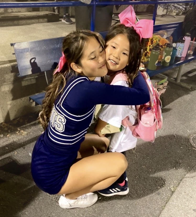 Post game smiles: Mini Monty’s express their joy after performing the dances and cheers they learned at the Mini Monty’s fundraiser. Mini Monty’s were all smiles after dancing their hearts out at the Carlmont varsity pink out football game.