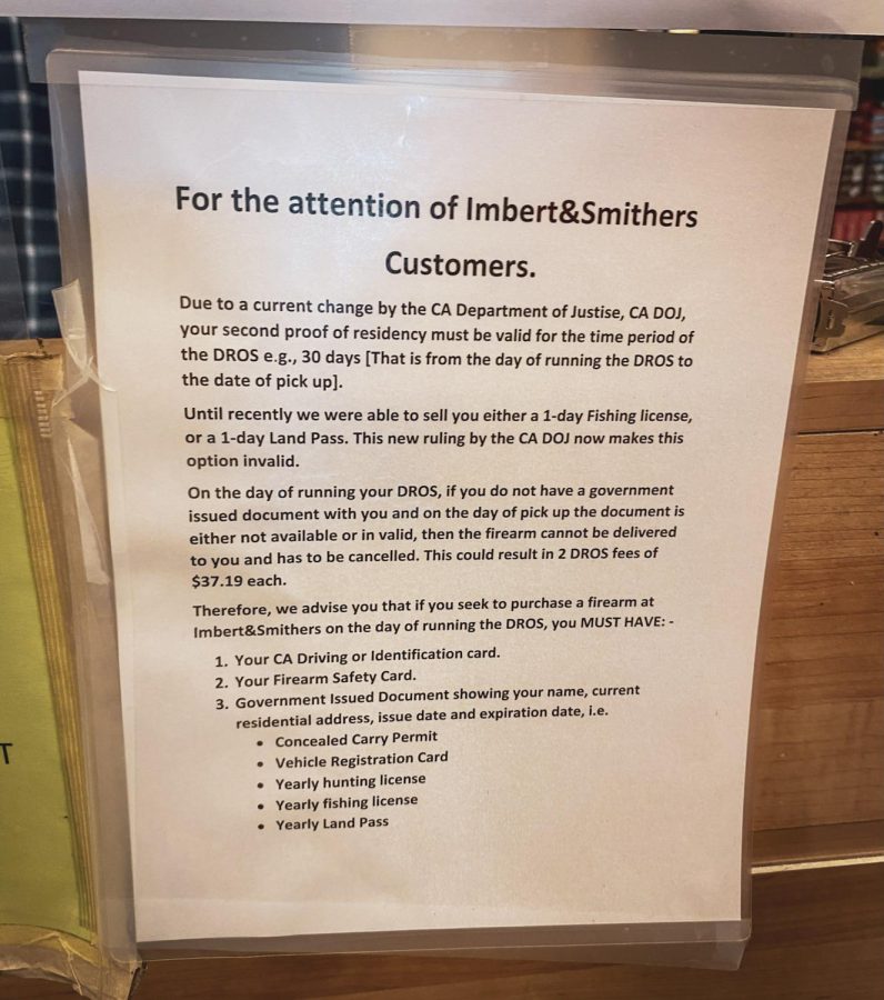 A sign posted on the inside of Imbert and Smithers informing customers of new California policies on purchasing firearms.