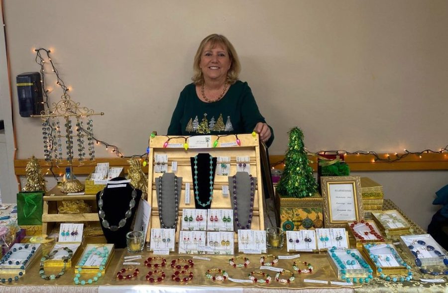 Donna Jones, a long time jewelry crafter, poses in front of her products at the craft fair. 