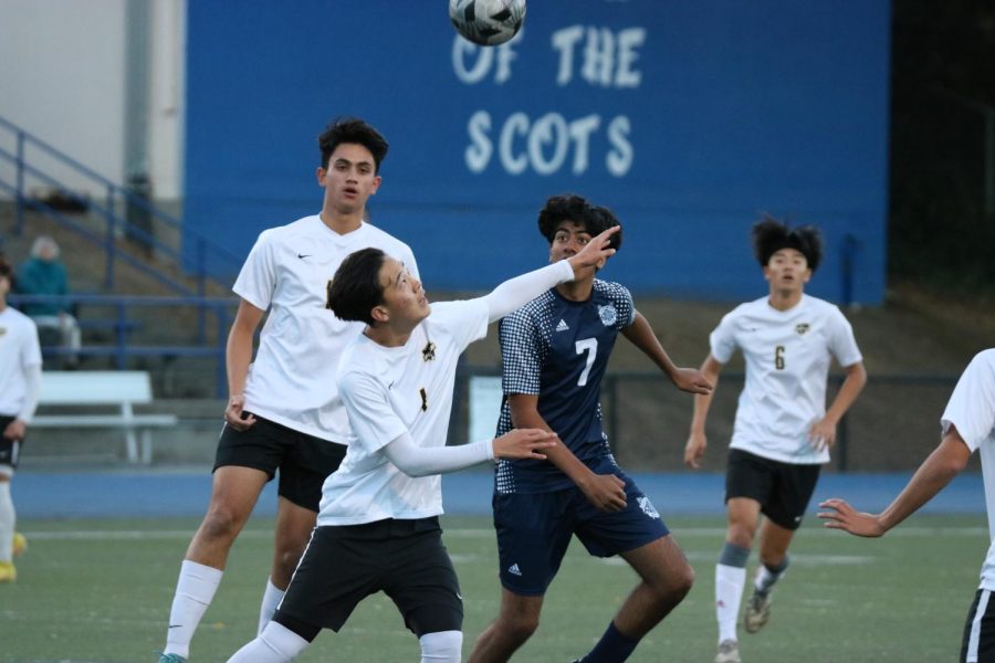 Carlmont senior Viraj Singh fights for a header at midfield.
