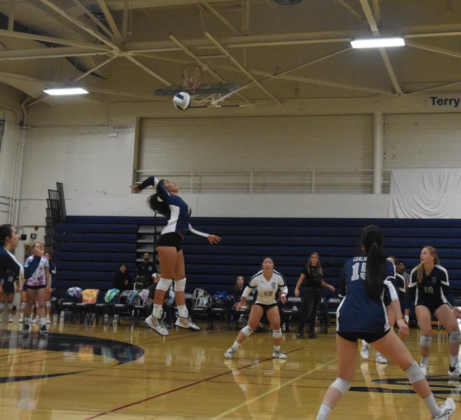 Freshman Alyssa Ison jumps high into the air to hit a backrow spike to the other team. Carlmont Varsity Girls Volleyball beat Sequoia in a close match. 
