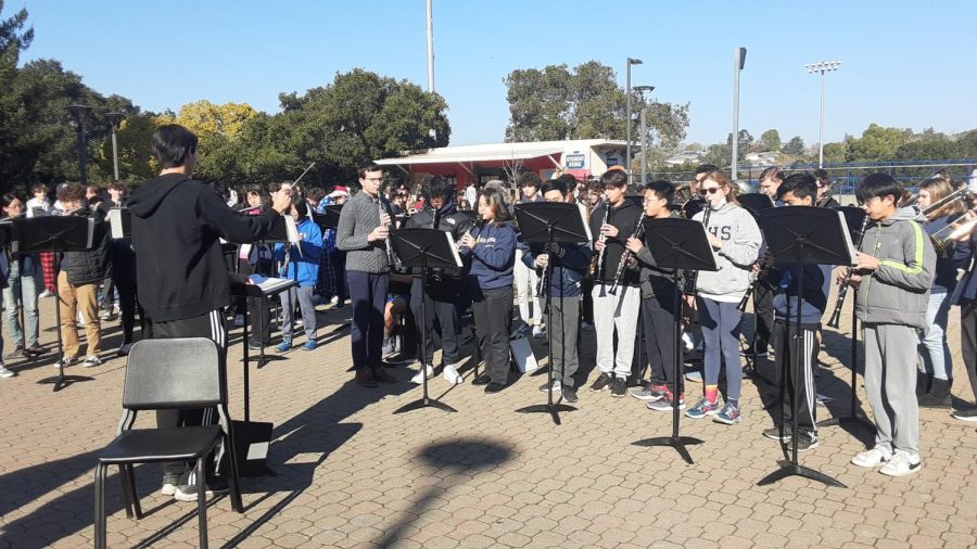 Symphonic Band plays two holiday pieces in the quad on the last day of review week. Led by student conductor and junior Aidan Yang, the group brought in a lively spirit to mark the end of the semester.