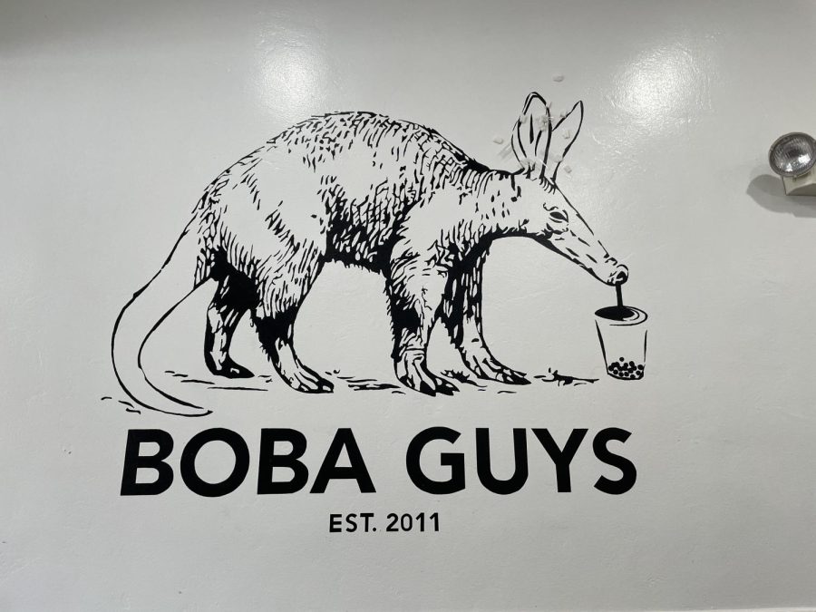 The Boba Guys sign with its signature anteater on the wall inside the San Carlos Boba Guys.