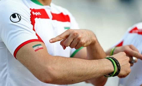 Iranian player pointing to their countrys  national flag before their match against Nigeria in the 2014 World Cup.
