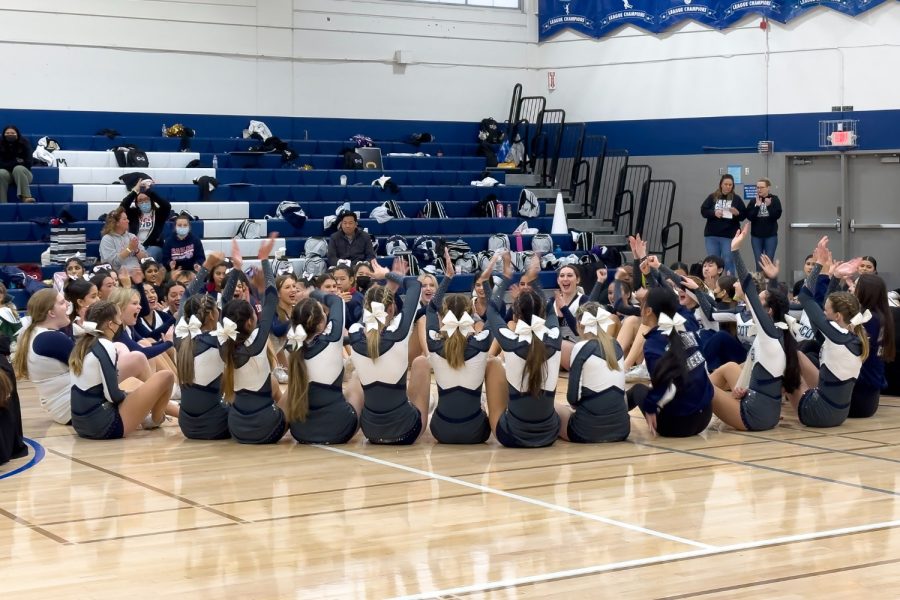 The JV and varsity cheer teams cheer after finding out that the varsity team won in their division.