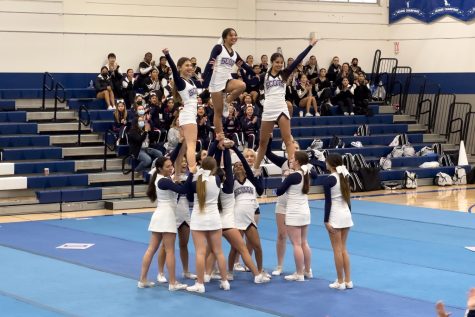 Spotters lift flyers Sarah Shalita, Makayla Miller, and Marina Mendez into a pose. Although they come from different sideline teams, the bond on the competition team is no different. Were all really nice and encouraging to each other, and its good, were all friends, Mendez said.