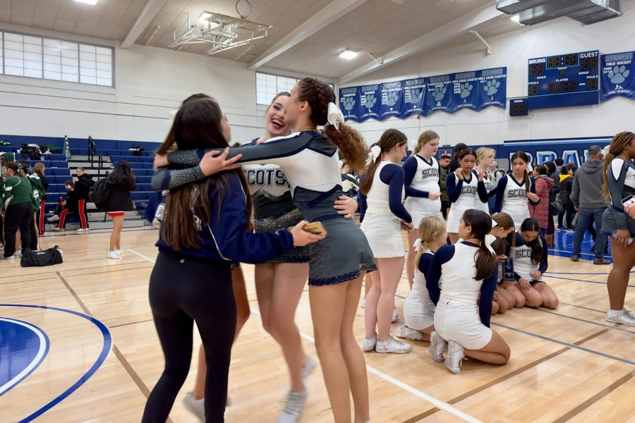 Cheerleaders celebrate after both of Carlmonts competition teams achieved first place in the Branham Invitational.