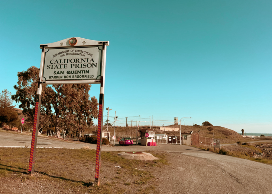 A sign stands in front of the road that leads to the entrance of San Quentin State Prison in San Quentin, California.