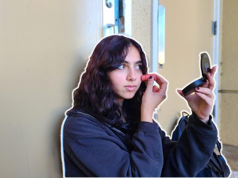 Sophomore Salma Gharib touches up her makeup during lunch.