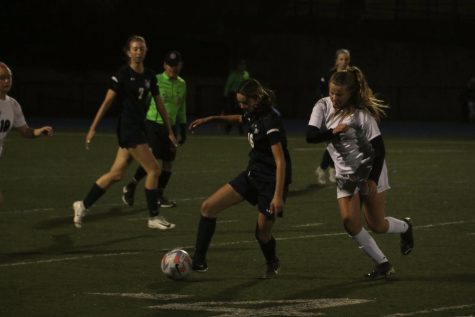 Freshman Sydney Lapin possesses the ball as a defender approaches her.
