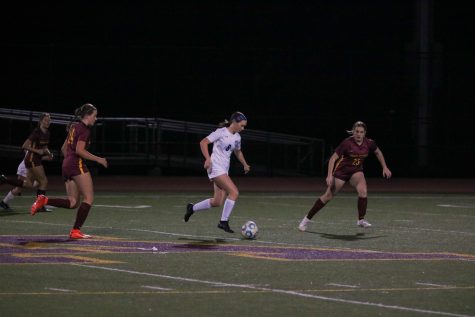 Sophomore striker Anika Bock dribbles up the field and toward the goal.