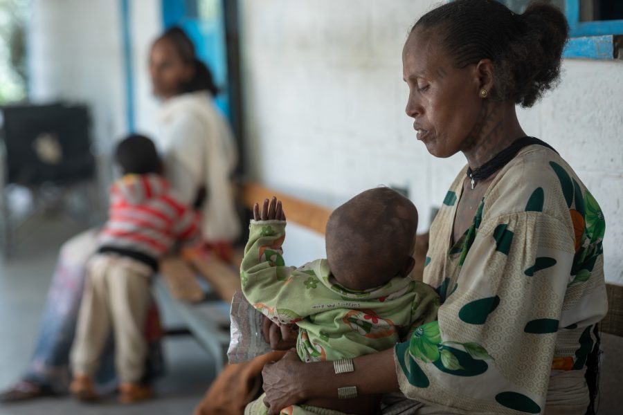 At Agbe Health center in the Tigray region of northern Ethiopia, a mother holds her 1-year-old son who is suffering from malnutrition. 