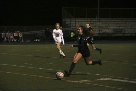 Sophomore Stella Lopez runs down the field with the ball.