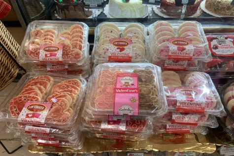 A supermarket advertises Valentines Day-themed desserts, which is a common but kind gift idea.