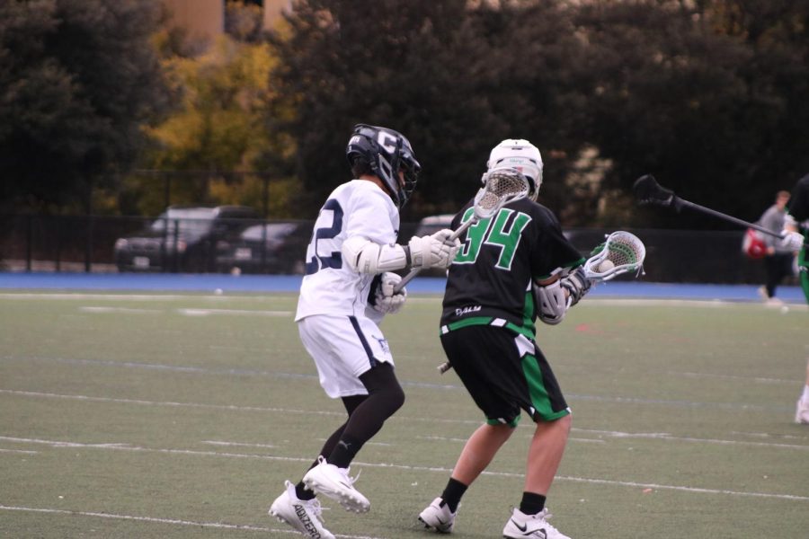 Freshman Adam Hyman plays midfield defense, trying to prevent the player from entering the box and scoring. 