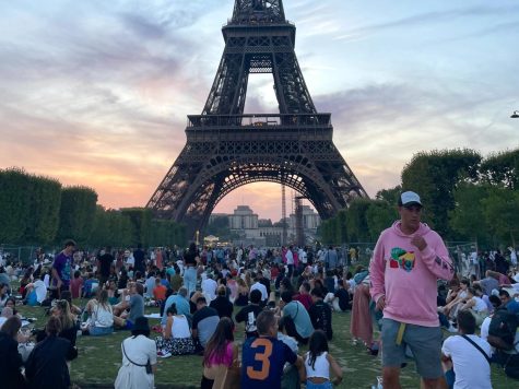 A crowd of tourists gather outside to look at the Eiffel Tower at sunset. The Eiffel Tower is one of the most well known tourist attractions in the world, drawing around 7 million people each year according to its official website. 75% of those visitors are foreigners.